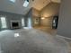 Bright living room featuring a fireplace, vaulted ceilings with skylights, and neutral carpet at 723 Bennett Rd, Carmel, IN 46032