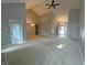 Open living room featuring vaulted ceilings and access to the backyard at 723 Bennett Rd, Carmel, IN 46032
