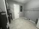 Clean utility room with tile flooring, shelving, and essential equipment at 723 Bennett Rd, Carmel, IN 46032