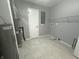 Clean utility room with tile floors, water heater, HVAC system, and storage shelves at 723 Bennett Rd, Carmel, IN 46032