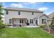 Spacious backyard featuring a patio with a pergola, outdoor seating, and lush green lawn at 7249 Red Maple Dr, Zionsville, IN 46077