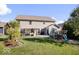 Spacious backyard with a large lawn, patio seating area, and a playset for outdoor enjoyment at 7249 Red Maple Dr, Zionsville, IN 46077