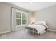 Bright bedroom with large window, neutral colors, and comfortable furnishings at 7249 Red Maple Dr, Zionsville, IN 46077