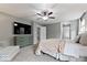 This stylish bedroom features a ceiling fan, television, and ensuite access at 7249 Red Maple Dr, Zionsville, IN 46077
