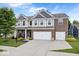 Charming two-story home featuring brick and siding, a well-manicured lawn, and a two-car garage at 7249 Red Maple Dr, Zionsville, IN 46077