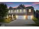 Charming two-story home with brick and siding, a well-manicured lawn, and a three car garage at 7249 Red Maple Dr, Zionsville, IN 46077