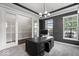Modern home office with dark gray walls, white trim, and a stylish spherical light fixture at 7249 Red Maple Dr, Zionsville, IN 46077