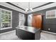 Stylish home office features modern lighting, a large desk, and a spacious wooden armoire at 7249 Red Maple Dr, Zionsville, IN 46077