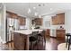 Stylish kitchen with stainless steel appliances, a center island with seating, and dark wood cabinets at 7249 Red Maple Dr, Zionsville, IN 46077