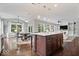 Open-concept living area with kitchen island, dining space, and large windows offering ample light at 7249 Red Maple Dr, Zionsville, IN 46077