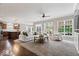 Spacious living room with large windows, neutral carpet, and an open layout connecting to the kitchen at 7249 Red Maple Dr, Zionsville, IN 46077