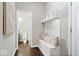 Inviting mudroom with a bench, cubbies, and access to a well-appointed half-bathroom at 7249 Red Maple Dr, Zionsville, IN 46077