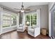 Cozy sunroom with plush armchairs, natural light, and views of the backyard at 7249 Red Maple Dr, Zionsville, IN 46077