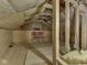 Unfinished attic space with exposed framing, insulation, and two red chairs at 730 N Forsythe St, Franklin, IN 46131