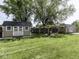 Spacious backyard with manicured lawn, two sheds, and a firepit area perfect for outdoor entertaining at 730 N Forsythe St, Franklin, IN 46131