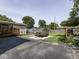Large backyard featuring a greenhouse, raised garden beds, firepit, a trailer and a deck at 730 N Forsythe St, Franklin, IN 46131