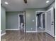 Bedroom includes wood-look floors, fresh green paint, multiple closets and ceiling fan at 730 N Forsythe St, Franklin, IN 46131