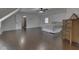 A bedroom with a wood dresser, gray bedding, wood floors, and a view into the doorway at 730 N Forsythe St, Franklin, IN 46131