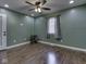 This bedroom features wood-look floors, fresh green paint, and a ceiling fan with light fixture at 730 N Forsythe St, Franklin, IN 46131