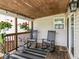 Cozy covered porch featuring rocking chairs, indoor/outdoor rug, hanging flowerpots, and a welcome mat at 730 N Forsythe St, Franklin, IN 46131