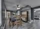 Open dining area with modern flooring, a stylish ceiling fan, and vintage-style furniture at 730 N Forsythe St, Franklin, IN 46131