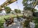 Charming firepit area featuring a gravel surround, pergola, string lighting and six adirondack chairs at 730 N Forsythe St, Franklin, IN 46131