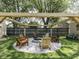 Inviting backyard firepit area with gravel surround, seating, and overhead pergola lighting at 730 N Forsythe St, Franklin, IN 46131