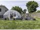 Backyard greenhouse with raised garden beds and lush landscaping, perfect for gardening enthusiasts at 730 N Forsythe St, Franklin, IN 46131