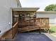 Side view of a wooden deck with ramp, covered patio, and vinyl siding at 730 N Forsythe St, Franklin, IN 46131