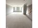 Unfinished, open-concept living space with abundant natural light and staircase at 7305 Bayview Run # 13-605, McCordsville, IN 46055