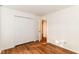 Bright bedroom featuring wood floors and a closet with white paneled doors at 7657 Winding Creek Dr, Indianapolis, IN 46236