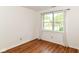 Bedroom with hardwood floors, a large window, and white curtains at 7657 Winding Creek Dr, Indianapolis, IN 46236