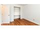 Bright bedroom with hardwood floors and a built-in closet and shelving at 7657 Winding Creek Dr, Indianapolis, IN 46236