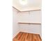 Walk-in closet with ample storage options, featuring white walls and sleek flooring at 7657 Winding Creek Dr, Indianapolis, IN 46236