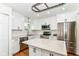 Modern kitchen with stainless steel appliances, white cabinets, and a center island at 7657 Winding Creek Dr, Indianapolis, IN 46236