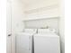 Clean laundry room with white appliances and shelving at 7657 Winding Creek Dr, Indianapolis, IN 46236