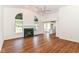 Bright living room featuring hardwood floors, a fireplace, and a view of the kitchen at 7657 Winding Creek Dr, Indianapolis, IN 46236