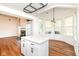 Open concept living space featuring new floors, fireplace, and island with bar seating at 7657 Winding Creek Dr, Indianapolis, IN 46236