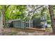 Backyard view showcasing the home's deck and surrounding trees at 7803 Harbour, Indianapolis, IN 46240