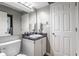 Comfortable bathroom featuring a marble countertop, integrated sink, and white fixtures at 7803 Harbour, Indianapolis, IN 46240