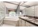 Serene bathroom featuring a soaking tub, large window, and integrated vanity for a relaxing experience at 7803 Harbour, Indianapolis, IN 46240