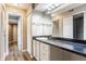 Well-lit bathroom with a large vanity, sleek countertop, and convenient storage cabinets at 7803 Harbour, Indianapolis, IN 46240