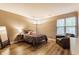 Cozy bedroom featuring a plush bed, chair, and ample natural light from a window at 7803 Harbour, Indianapolis, IN 46240