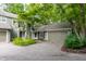 Charming home exterior featuring a lush, tree-lined yard and attached garage at 7803 Harbour, Indianapolis, IN 46240