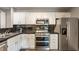 Modern kitchen with stainless steel appliances, granite countertops, and white cabinetry at 7803 Harbour, Indianapolis, IN 46240