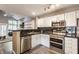 Bright kitchen with stainless steel appliances and a view into the living area at 7803 Harbour, Indianapolis, IN 46240
