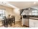 Bright eat-in kitchen featuring stainless steel appliances and an adjacent dining area with a view of the upper level at 7803 Harbour, Indianapolis, IN 46240