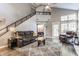Spacious living room with a cozy couch, high ceilings, and access to upper level at 7803 Harbour, Indianapolis, IN 46240