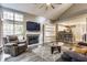 Comfortable living room featuring a fireplace, bar seating, and natural light at 7803 Harbour, Indianapolis, IN 46240