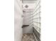 Modern shower featuring a glass block window, built-in shelving, and stone-tiled floors at 7803 Harbour, Indianapolis, IN 46240